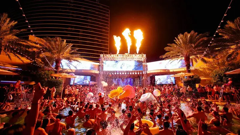 Encore Beach at Night photo gallery image with illuminated evening pool scene.