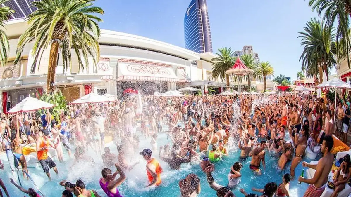 Encore Beach Club venue video thumbnail with daytime pool-party crowd, palm trees, and stage view.
