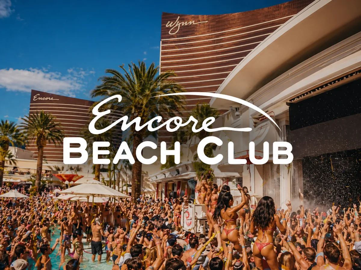 Encore Beach Club at Wynn Las Vegas with daytime pool-party crowd and palm-lined resort backdrop.